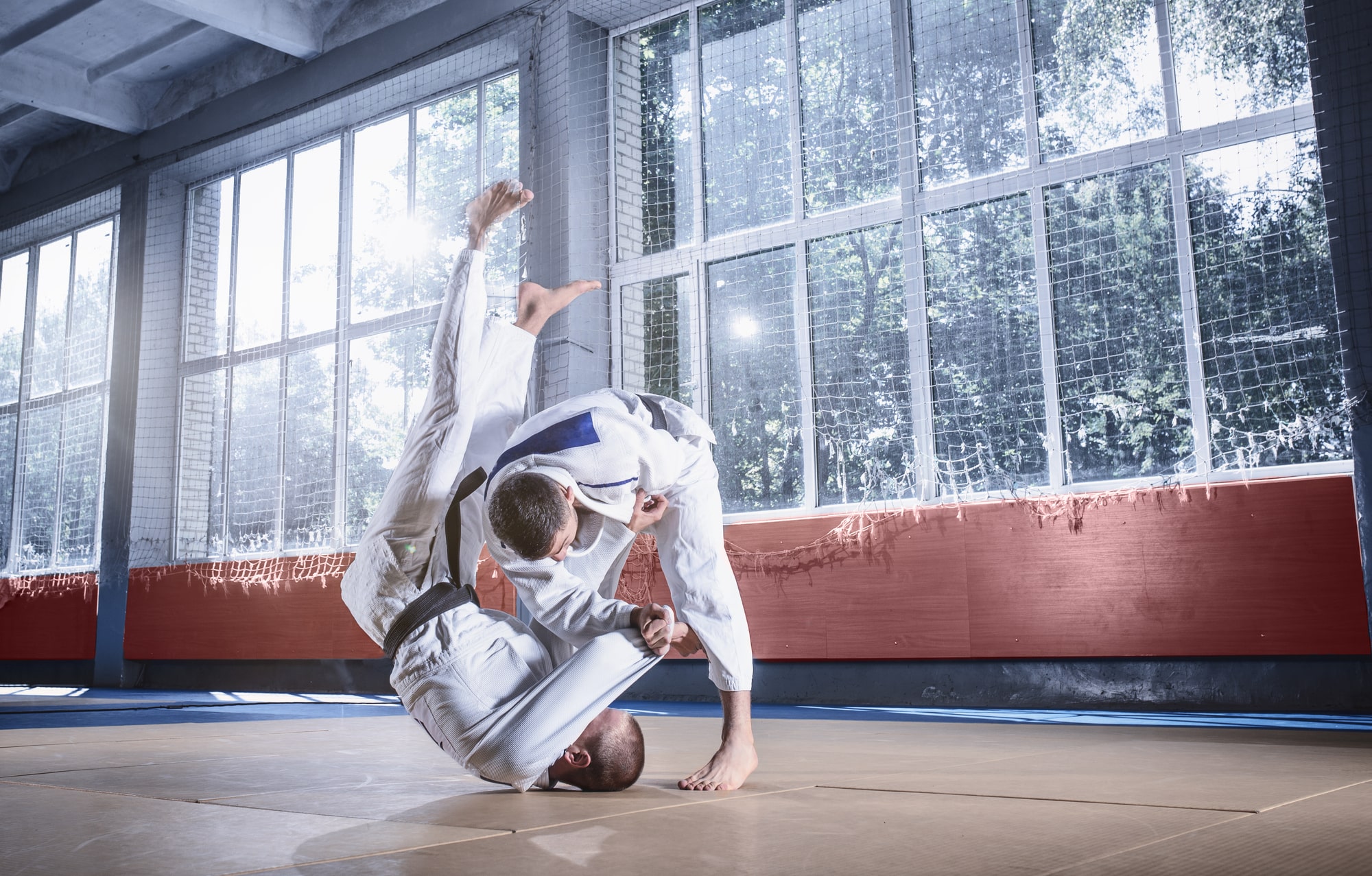 Two judo fighters showing technical skill while practicing martial arts fight club min